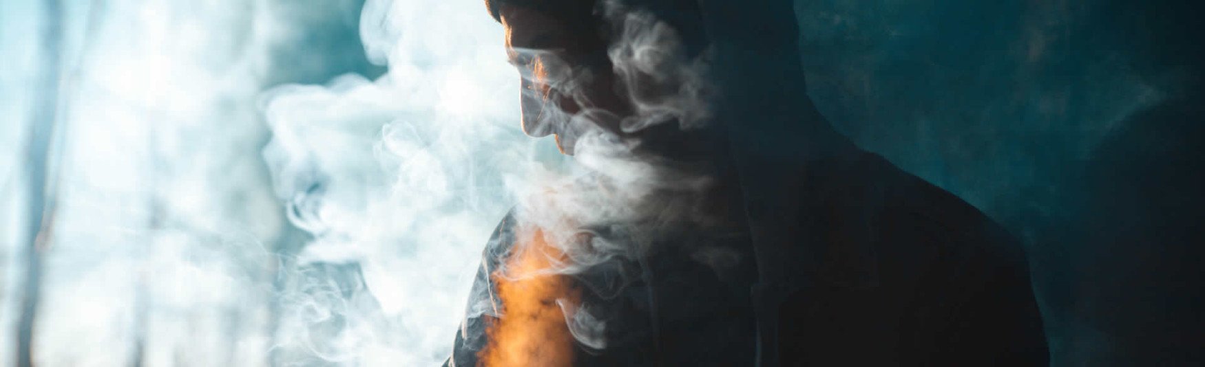 person surrounded by cigarette smoke
